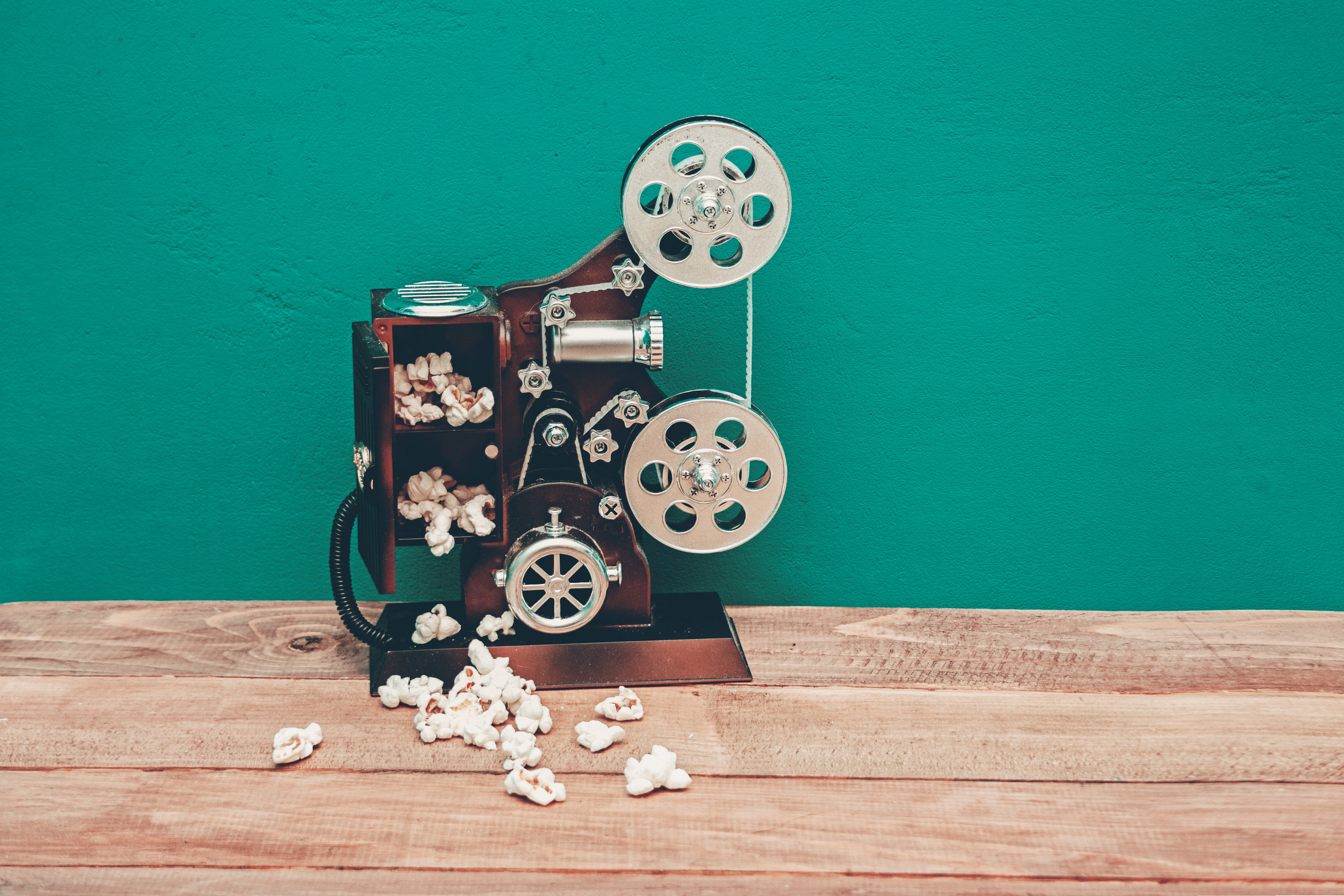 An old film projector in front of a green screen